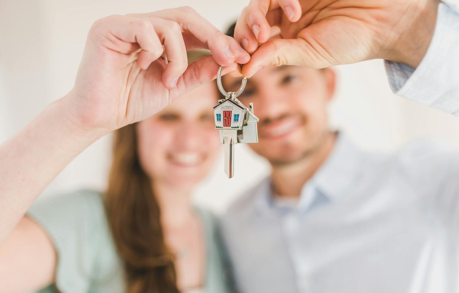 Happy Couple Holding and Showing a House Key