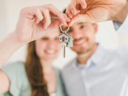 Happy Couple Holding and Showing a House Key