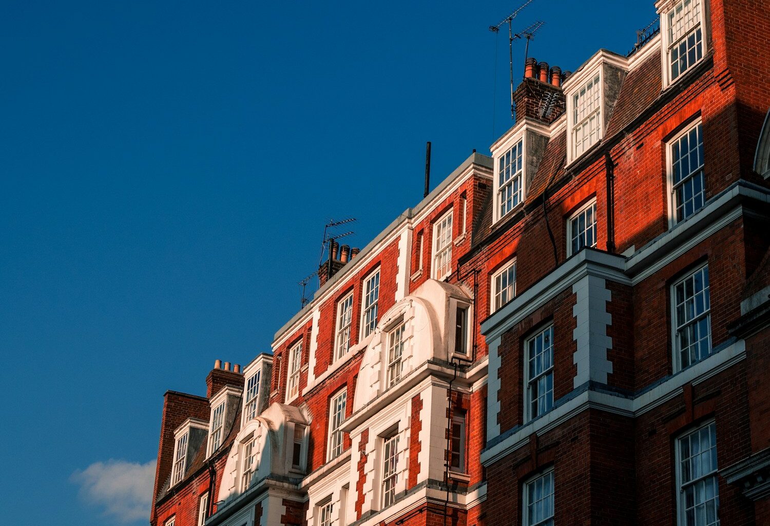 brown and white concrete building under blue sky during daytime